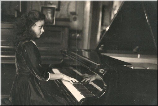 Betty Verlooy au piano dans le salon de la maison familiale, âgé d’environ 12 ans.
